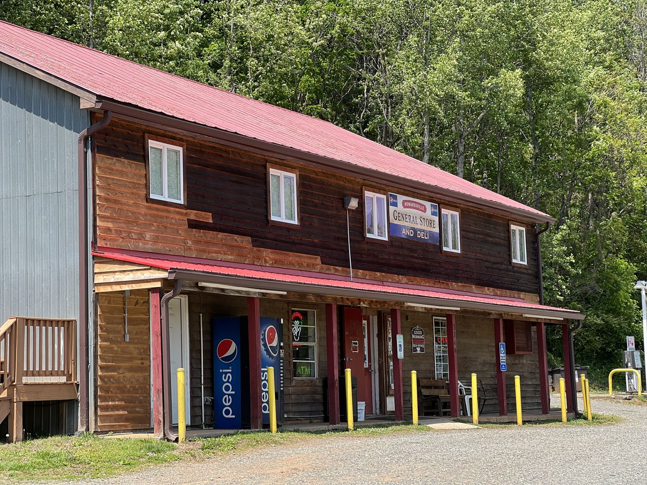 The Howardsville General Store storefront — a wooden building with a red roof and the painted sign reading Howardsville General Store and Deli.